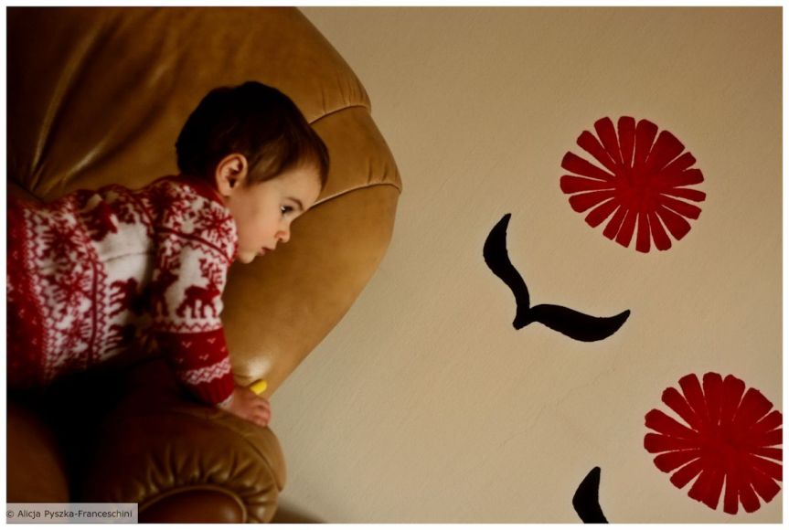 A little child looking with curiosity at something